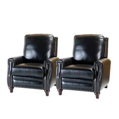 a pair of black leather chairs sitting next to each other