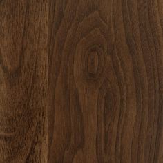 closeup of the wood grains on an oak flooring paneled in dark brown