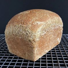 a loaf of bread sitting on top of a cooling rack