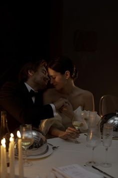 a man and woman sitting at a dinner table