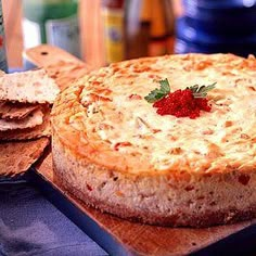 there is a cheese cake on the table with crackers