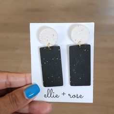 a pair of black and white earrings on a card with the word ellie rose written in it