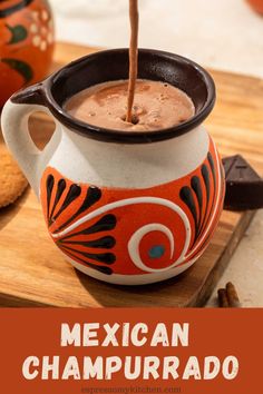 mexican chapurado in a ceramic pitcher with cinnamon sticks sticking out of it