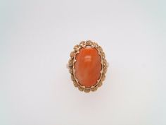 Vintage 18 Karat Yellow Gold Oval Coral Ring With Floral Halo  Oval Coral = 15 X 10 Mm  20 Mm Wide  Finger Size 6 Thanks for shopping with us! Victoria Ashley Fine Jewelry is proud to offer exquisite vintage & handmade jewelry that will make your heart flutter. Our passion for jewelry is fueled by a desire to help you find the perfect piece of jewelry.  Our standard shipping takes 2-3 business days with a signature required upon delivery. We are happy to offer returns or exchanges of the original purchase price, excluding shipping or other additional charges, on merchandise within 14 days of delivery. The item(s) must be in original condition without any damage or alterations in order to qualify. Return shipping shall be arranged & paid for by the buyer. All of our gorgeous jewels are also Gold Oval Multi-stone Jewelry, Formal Multi-stone Oval Cabochon Jewelry, Yellow Gold Gemstone Cabochons, Yellow Gold Oval Cabochon Gemstones, Gold Multi-stone Oval Cabochon Ring, Formal Oval Cabochon Jewelry, Oval Multi-stone Jewelry For Formal Occasions, Oval Multi-stone Cabochons For Gifts, Formal Orange Oval Rings