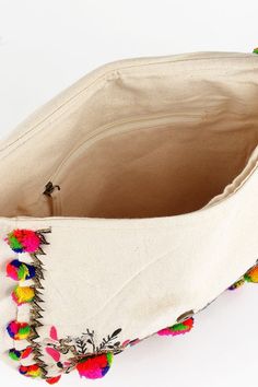 the inside of a bag with pom poms on it