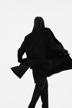 Silhouette of a man walking against a white background. Wearing a black coat. Silhouette Of A Man, Black Coat, A Black, White Background, Walking