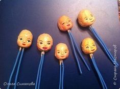 five heads are lined up with toothpicks in the shape of people's faces