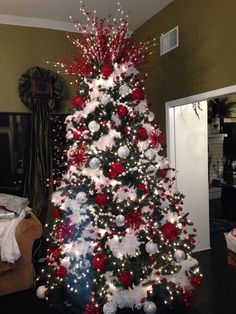 a christmas tree decorated with red, white and silver ornaments