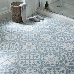 a bathroom with a large tile floor next to a shower