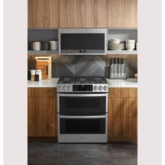 two ovens in a kitchen with wooden cabinets