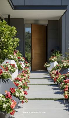 the entrance to a modern home with flowers in pots