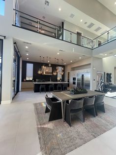 a large open floor plan living room and dining area with stairs leading to the upper level