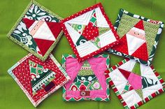 quilted christmas coasters on green fabric with red and white santa's face