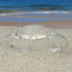 "This bracelet is made of sterling silver with a starfish that has been engraved on the center piece. Because it is hinged and connected by a hook it is very easy getting on and taking off. This bracelet is so comfortable you will hardly know it is there. Most people just leave it on all the time. This bracelet makes a very cute gift. Each bracelet is individually hand crafted to size for purchaser. To determine your size, measure the wrist with a peice of string and then add a 1/2\". For exampl Silver Starfish Bracelet, Silver Starfish Bracelet For Gift, Adjustable Silver Starfish Jewelry, Horse Bracelet, Starfish Bracelet, Cute Gift, Gold Leather, Beautiful Bracelet, Starfish