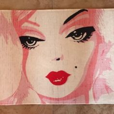 a woman's face painted on wood with the words poshmark $ 59