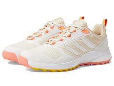 a woman's adidas running shoe with orange and white accents on the sole