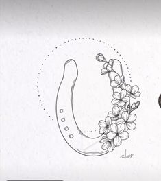 a drawing of a horseshoe with flowers on it and the letter o in the middle