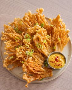 fried food on a plate with dipping sauce