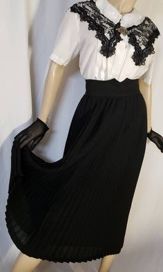 Stunning accordion skirt in black . This pleated skirt closes with 2 buttons and a zipper at the back  The skirt is lined with acetate  The exterior is wool and polyester blend  The skirt is a vintage size  S but fits best size XS  Waist 22 to 24 inches ( 56 to 61 cm ) See measurements on photo please  Excellent vintage condition Black Fitted Pleated Skirt With Accordion Pleats, Black Flowy Pleated Skirt For Formal Events, Black Flowy Pleated Skirt For Formal Occasions, Formal Black Flowy Pleated Skirt, Black Fitted Skirt With Accordion Pleats, Formal Fitted Long Pleated Skirt, Black Pleated Skirt For Evening With Accordion Pleats, Black Evening Pleated Skirt With Accordion Pleats, Black Pleated Skirt For Evening