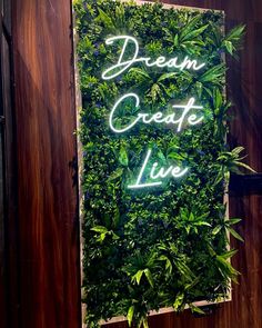 Dream Create Live Neon Sign Faux Plant Wall With Neon Sign, Neon Signs On Grass Wall, Backlit Wood Sign, Neon Sign With Greenery, Beach Neon Sign, Wall Design Outdoor, Modern Home Exterior, House Front Wall Design, Business Decoration