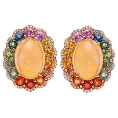 18K Yellow Gold Ethiopian Opal: 7.78 carats Multi-Colored Sapphires: 5.49 Diamond: 0.407 carats Length: .75'' Omega Backs Closure Sapphire And Diamond Earrings, Multi Sapphire, Sapphire Diamond, Gold Studs, Brilliant Cut Diamond, Diamond Studs, Ethiopian Opal, Or Rose, Modern Furniture