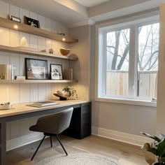 a home office with shelves, desk and chair in front of a large open window