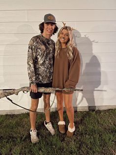 a man and woman dressed up as deer hunters