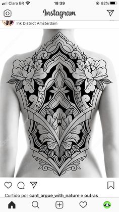 the back of a woman's body with an intricate tattoo design on her chest