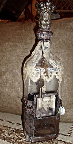 an old fashioned glass bottle sitting on top of a table next to a couch in a living room