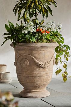 a planter filled with flowers and greenery