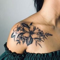 a woman with a flower tattoo on her shoulder