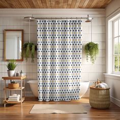 a bath room with a shower curtain and a rug in front of the tub area