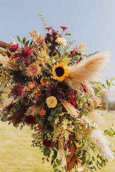 Autumn wedding at a Rustic Montana venue. Sunflower Fall Bouquet, Fall Wildflower Bouquet Boho Wedding, Fall Wedding Bouquets With Sunflowers, Fall Flowers Wedding, Colorado Flowers, Wedding In Montana, Sunflower Floral Arrangements, Moab Wedding, Fall Mountain Wedding