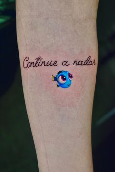 a person with a tattoo on their leg that says continue a nadder and an image of a fish