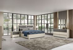 a bedroom with a bed, dressers and large windows in it's walls