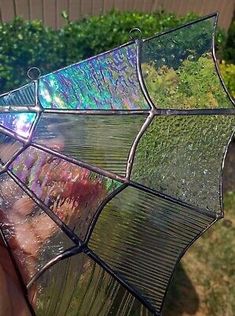 a person holding up a stained glass umbrella