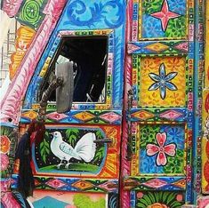 an artisticly painted truck is parked on the street