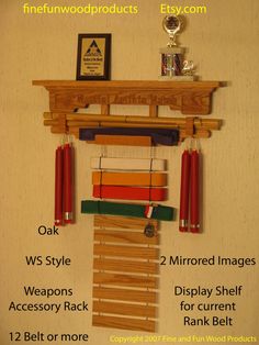 a wooden shelf with some red candles hanging from it's sides and other items on top