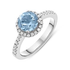 a blue topazte and diamond ring with white diamonds on the sides, set in 18k white gold