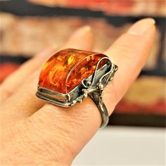 "LARGE AMBER STERLING Ring Size 9, Rare Big Baltic Honey Amber 925 Silver Rectangular Ring, Estate Amber Jewelry, Unique Holiday Gift For Her by ANTIQUE4YOU AMAZING OLD ART NOUVEAU GENUINE AMBER LARGE STONE and STERLING SILVER RING. BEAUTIFUL STERLING DECOR FROM ONE SIDE. SIZE US 9. HALLMARKED 925. UPPER PART 1 1/8\" x 1\" x 1/2\" . HIGH SETTING UNUSUAL 3D COGNAC AMBER STONE WITH A LOT OF INCLUSIONS. GREAT RARE GIFT FOR HER. UNISEX RING." Fall Wedding Ring, Shifting Closet, Rectangular Ring, Glitter Ring, Rare Gifts, Large Stone, Unique Holiday Gifts, Amber Ring, Amber Stone