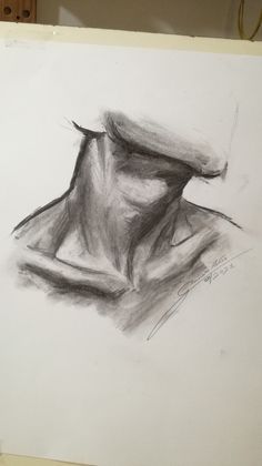 a drawing of a man's head in charcoal and white paper on a easel