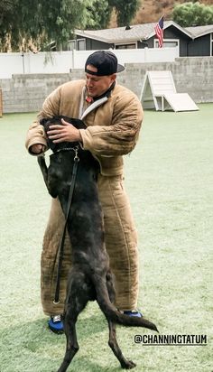 a man in a sumo suit is hugging his dog