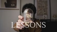 a person holding up a glass jar with a lizard inside it and the words lessons in front of them