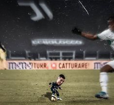 two men playing soccer on a field at night