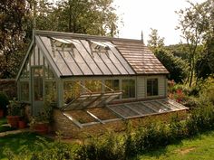 a small house with a glass roof in the garden