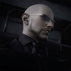 a bald man wearing sunglasses and a tie