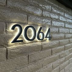 a brick wall with the number 2084 lit up in black on it's side