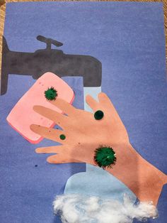 an image of someone washing their hands with soap and green balls on it's fingers