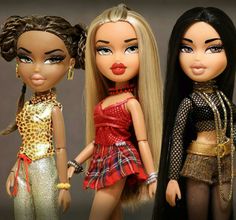 three dolls are standing next to each other in different outfits and hair styles, one is wearing a leopard print top