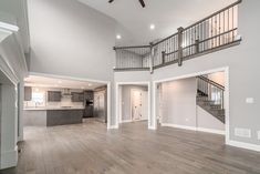 a large open floor plan with stairs leading to the kitchen and living room area,